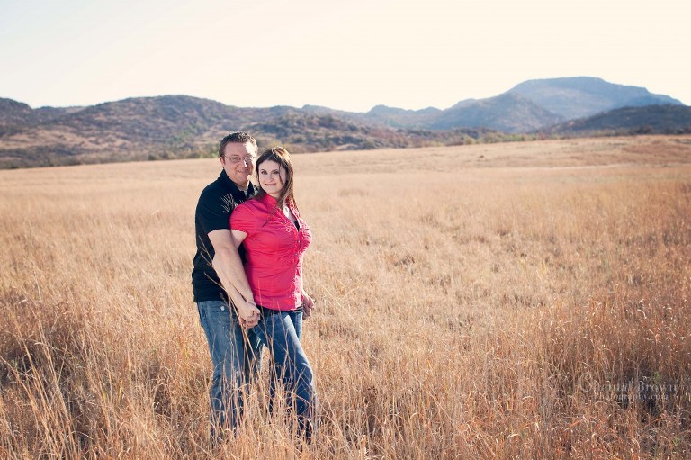 hugging-standing-on-beautiful-golden-field-lawton-engagement